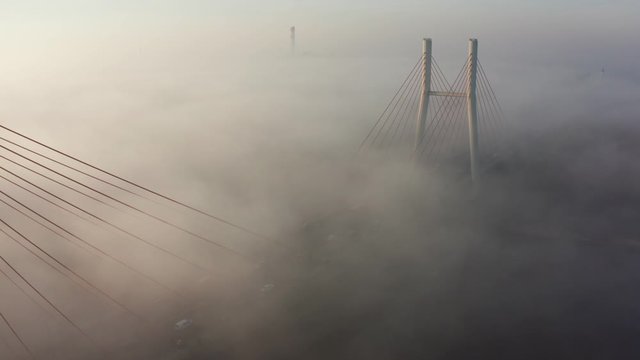 Aerial view. Siekierkowski, Bridge Spectacular Sunrise with low fog. View of the fog pattern around the Golden Gate Bridge. Warsaw. Poland. Drone Shot 4K.