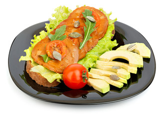 Vegan sandwich and vegetables on a plate