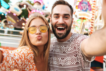 Loving couple walking outdoors in amusement park