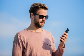 Important mobile conversation. Application and internet. Hipster wear sunglasses hold mobile phone...
