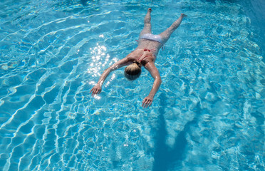 Woman face down in a swimming pool