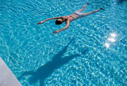 Woman face down in a swimming pool
