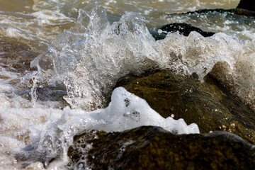 Sea seaside with stones, Waves of sea water crashing on rocks.