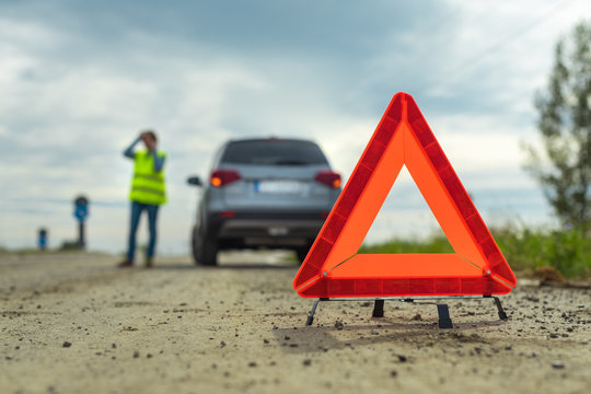 Vehicle Breakdown And Warning Triangle On The Road