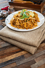 Pad Thai, vegan recipe made with rice noodles, vegetables and peanuts cooked on wok.