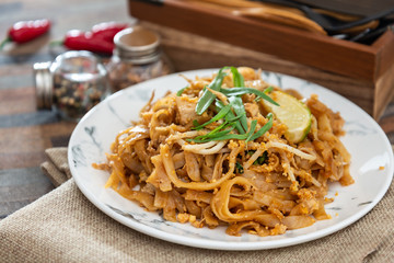 Pad Thai, vegan recipe made with rice noodles, vegetables and peanuts cooked on wok.