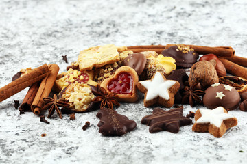 christmas cookies with spieses, nuts and fruits on rustic table