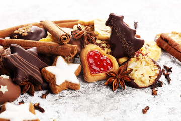 christmas cookies with spieses, nuts and fruits on rustic table