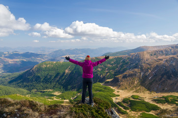 Fototapeta premium Happy female tourist in the mountains