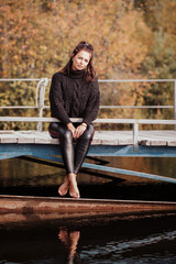 Girl walk on the beach.Colors of Ural autumn and female beauty