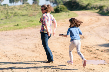 Mother and daughter playing in the field