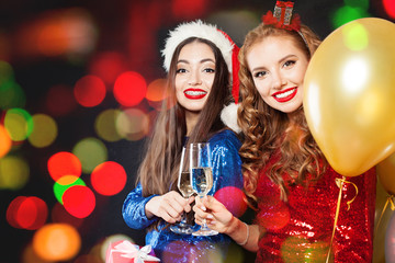 Christmas women friends on abstract bokeh glitter sparkle party background