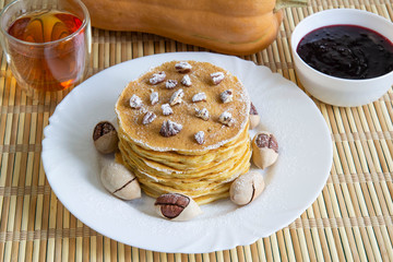Pumpkin pancakes with tea, currant jam and pecans