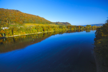 The river Rhine, only a few hundred meters young, after leaving Lake Constance. Autumn. Near the Swiss town Stein am Rhein. View from the car bridge to the west, the road leads to the Rhine Falls.