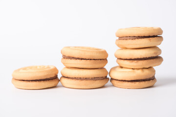 Fototapeta na wymiar Cookies stuffed with coffee cream stacked on a white background.