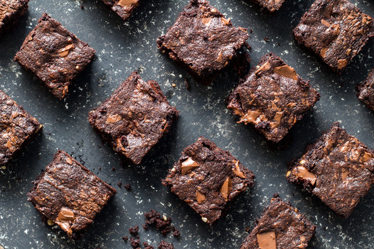 Chocolate brownies on mottled grey and white background
