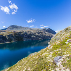 Fototapeta na wymiar blue lake Rondvatnet in Rondane National Park Norway