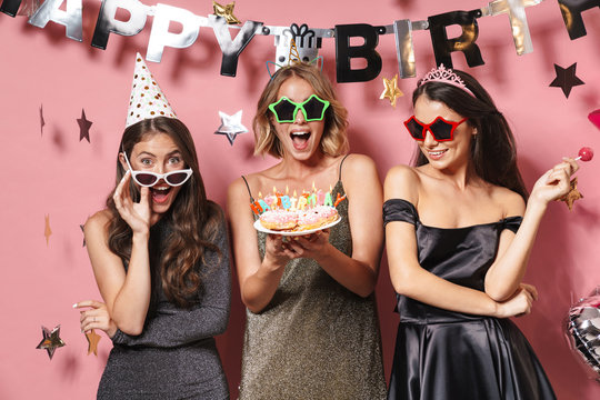 Image of beautiful party girls in glamour sunglasses holding birthday cake