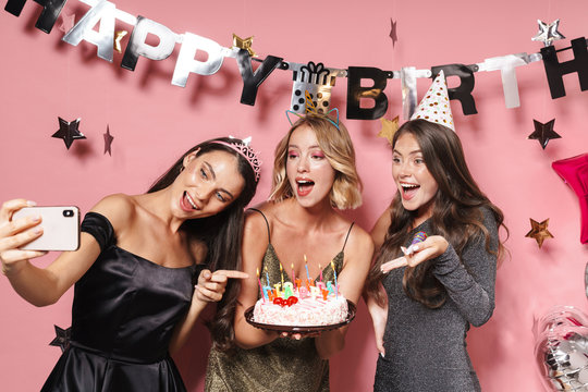 Image of party girls taking selfie photo and holding birthday cake