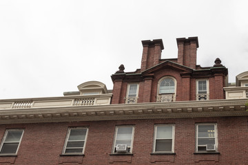 Old brick residential apartment building with roofline moulding details, horizontal aspect