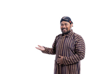 asian man with javanese traditional cloth lurik presenting to copyspace isolated