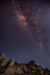 Milky Way over big rock rises in beautiful dark sky.. Night photography. Long exposure
