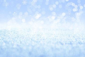 Winter abstract, blurred background with bokeh. Sparkling snow in the sunshine, blurry lights