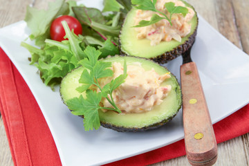 avocado with surimi and mayonnaise on a plate