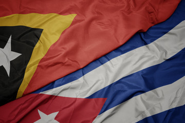 waving colorful flag of cuba and national flag of east timor.