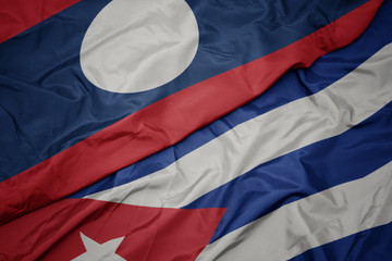 waving colorful flag of cuba and national flag of laos.