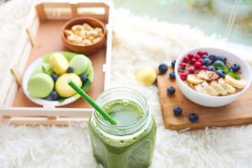 matcha green tea, breakfast top view white background. oatmeal with berries, toasts on a wooden tray, nuts, coffee