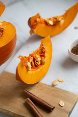 pumpkins with cinnamon sticks on marble backgrund