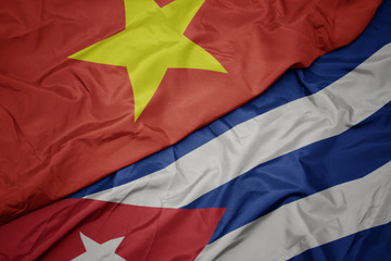 waving colorful flag of cuba and national flag of vietnam.