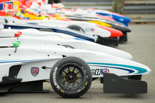 Line of race cars in the 'park firme' paddock during the Formula Renault Championships at Thruxton, UK. May 1, 2011