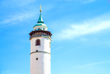 Fototapeta na wymiar White tower in Domazlice with blue sky