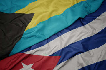 waving colorful flag of cuba and national flag of bahamas.