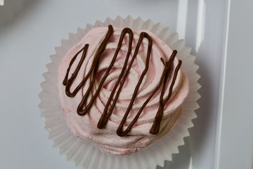 Aerial pink cherry marshmallows. Sprinkled with dextrose. Garnished with Chocolate. Close-up.
