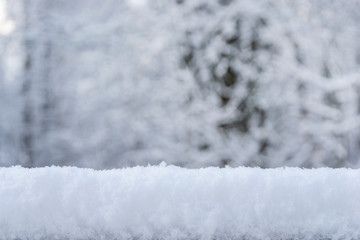 Christmas background with snow and snowflakes on a blurred natural background. Happy New Year, festive mood. Winter background. Copy space.