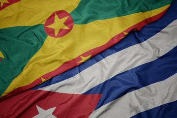 waving colorful flag of cuba and national flag of grenada.