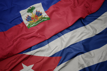 waving colorful flag of cuba and national flag of haiti.