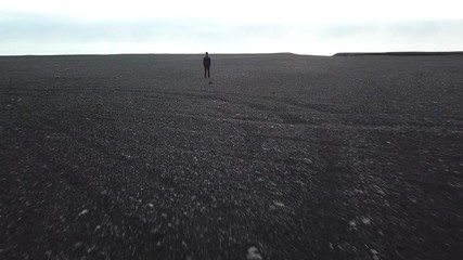 isolation concept, incognito, zoom out of man standing alone from the back, approach