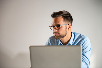 Young man working at his office