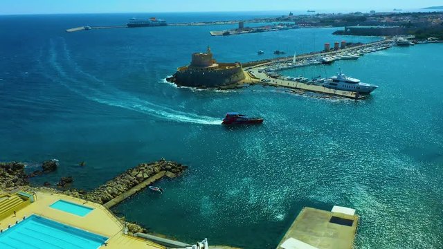 Aerial birds eye view video taken by drone of Rhodes island town Mandraki port popular summer tourist destination, Dodecanese, Aegean, Greece