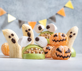 Healthy Fruit Halloween Treats. Banana Ghosts, Clementine Orange Pumpkins and Apple Monster Mounts