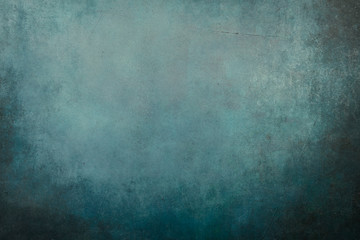 Fototapeta na wymiar Blue grungy backdrop with dark vignette borders