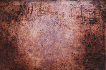 Overhead view scratched grunge sheet of copper metal. Texture with light vignetting. 