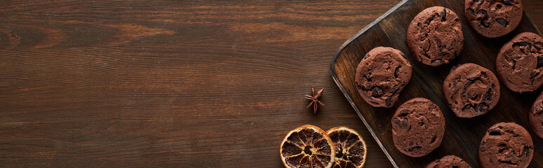 top view of chocolate cookies on wooden table, panoramic shot