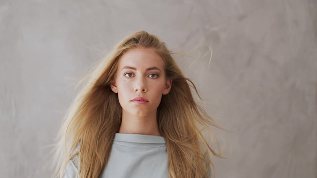 Portrait of beautiful blonde woman, hair blowing in wind
