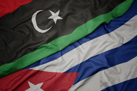 waving colorful flag of cuba and national flag of libya.