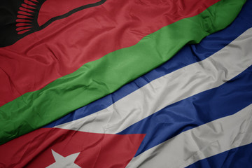 waving colorful flag of cuba and national flag of malawi.